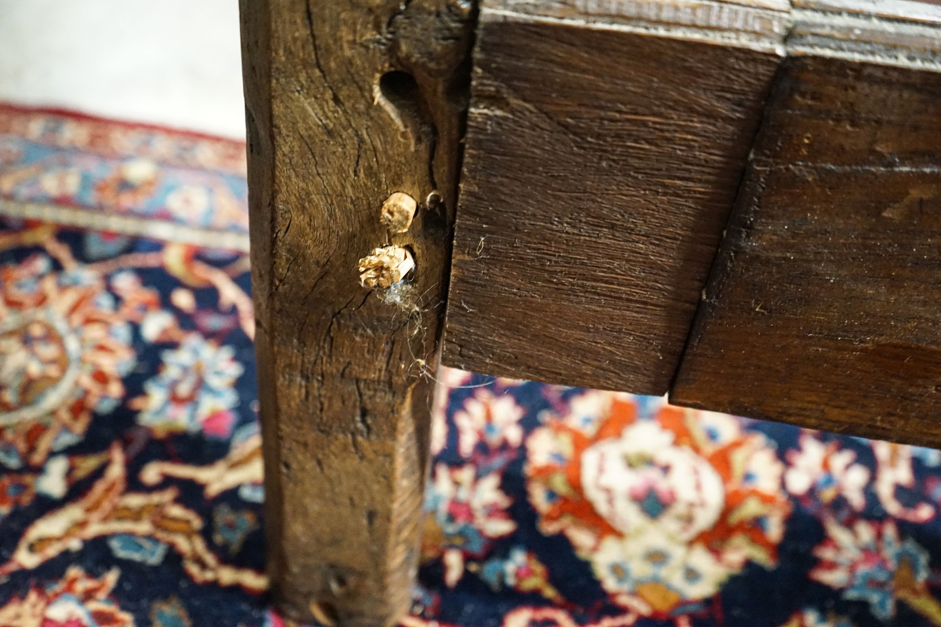 A 17th century style panelled oak bedstead, width 158cm, length 208cm